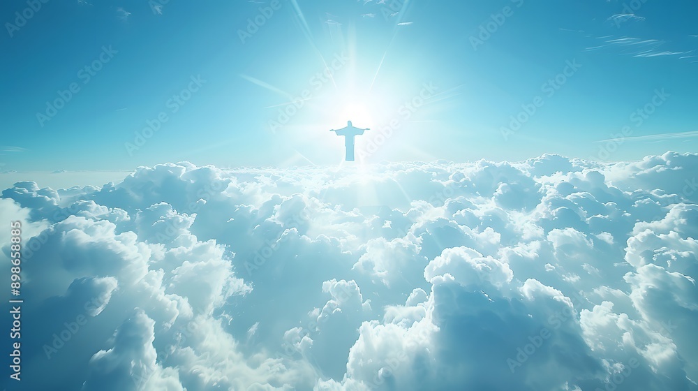 Fototapeta premium A breathtaking view of clouds with a luminous sun shining behind a towering statue, creating a serene and uplifting atmosphere.