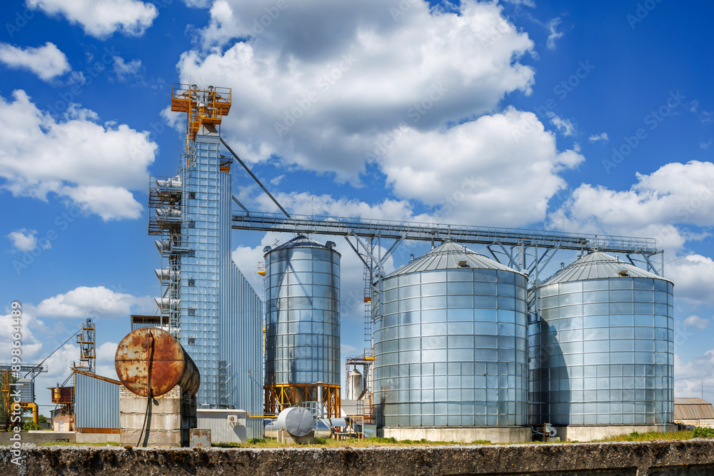 silos on agro-industrial complex with seed cleaning and drying line for grain storage. Granary elevator silos on agro-industrial complex with seed cleaning and drying line for grain storage. Granary elevator