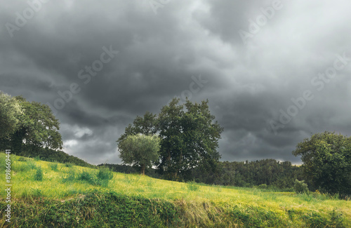 Rural landscape with stormy...