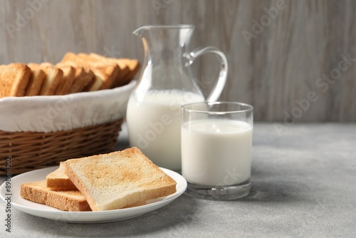 Delicious toasts served with milk on light table