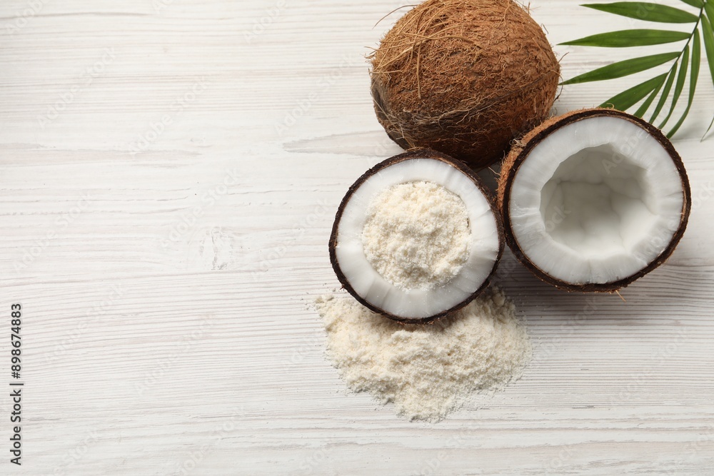 Fresh coconut flour, nuts and palm leaf on wooden table, space for text Fresh coconut flour, nuts and palm leaf on wooden table, space for text