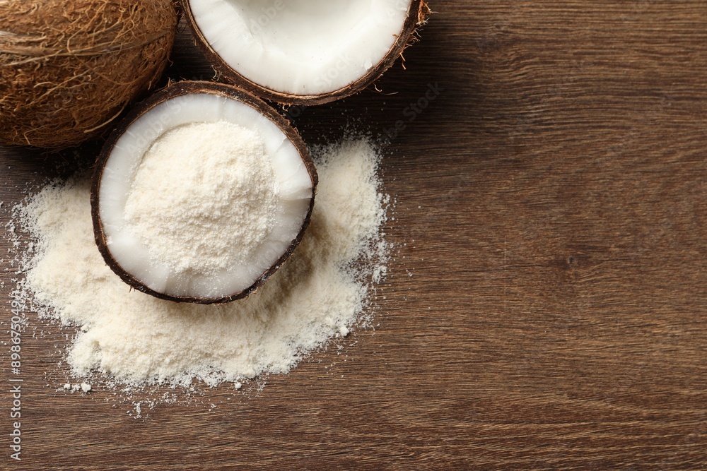 Coconut flour and fresh fruits on wooden table, flat lay. Space for text Coconut flour and fresh fruits on wooden table, flat lay. Space for text
