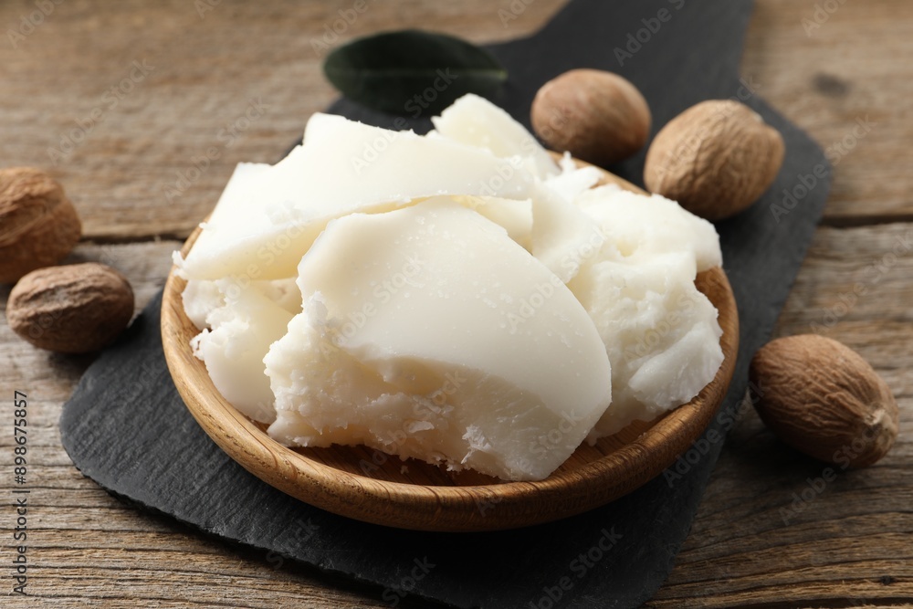 Natural shea butter and nuts on wooden table, closeup Natural shea butter and nuts on wooden table, closeup