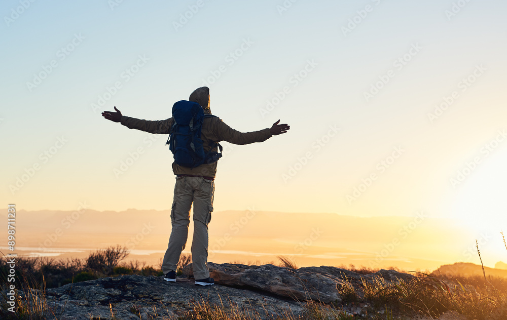 Mountain, sunset sky and person with hiking achievement, freedom or trekking vacation with backpack. Heaven, prayer and hiker with arms raised on cliff for outdoor adventure holiday success in nature