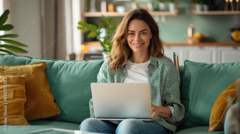A smiling woman sits comfortably in a cozy living room with soft lighting, working on her laptop and surrounded by tasteful decor, embodying a modern work-from-home scene. A smiling woman sits comfortably in a cozy living room with soft lighting, working on her laptop and surrounded by tasteful decor, embodying a modern work-from-home scene.