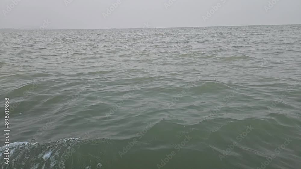 Slow motion side view of sea surface from a boat at Chilika Lake. Odisha state on the east coast of India. Slow motion side view of sea surface from a boat at Chilika Lake. Odisha state on the east coast of India.