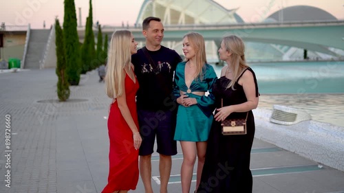 Family posing to camera and talking in outside near the fountain in Palau de les Arts photo