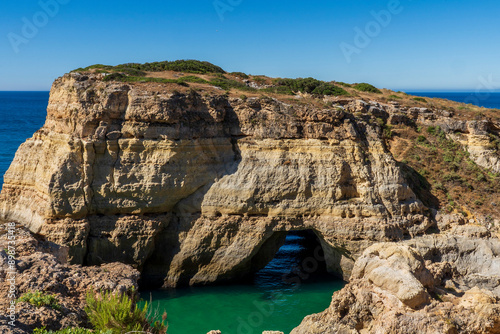 Coastline and Benegil Caves as seen from the Seven Hanging Valleys Trail, this trail encompasses the coastline between Marinha Beach and Vale Centeanes Beach, Lagoa municipality, Algarve, Portugal.