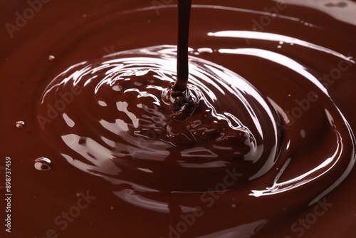 Closeup view of pouring delicious melted chocolate