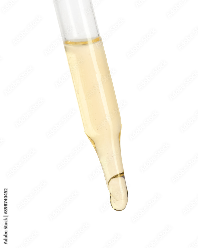 Dripping essential oil from pipette on white background Dripping essential oil from pipette on white background