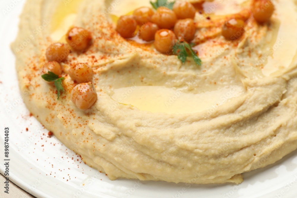 Delicious hummus with olive oil, chickpeas and paprika on table, closeup Delicious hummus with olive oil, chickpeas and paprika on table, closeup