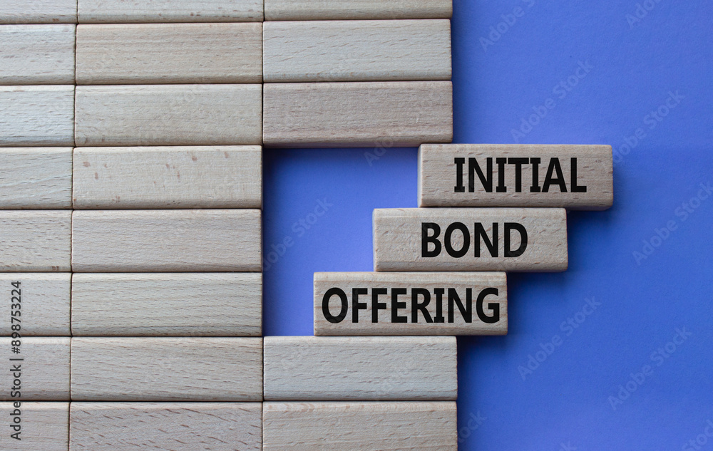 Obraz premium Initial Bond Offering symbol. Concept words Initial Bond Offering on wooden blocks. Beautiful purple background. Business and Initial Bond Offering concept. Copy space