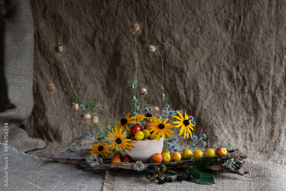 Fototapeta premium floral composition of wildflowers using cherry plum fruits and bird feathers. naturalistic style.