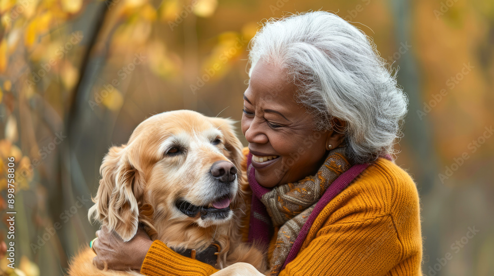 Happy senior woman embracing her dog outdoors in fall Happy senior woman embracing her dog outdoors in fall