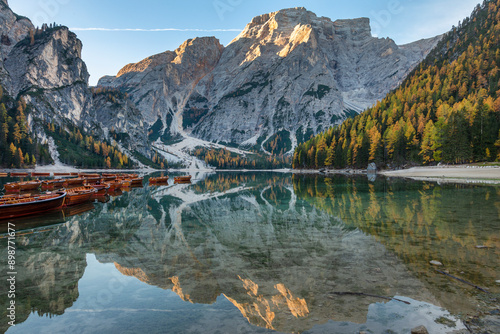 Lago di braies lake in the dolomites in autumn, reflection on the water