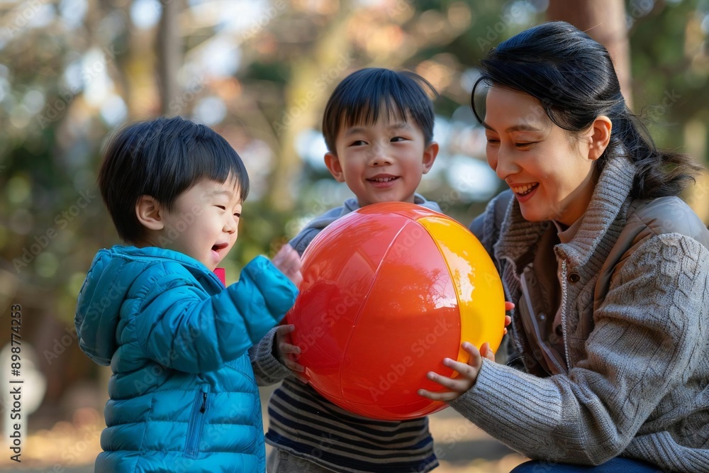 Full body photo of Asian family playing with beach ball at the park. Full body photo of Asian family playing with beach ball at the park.