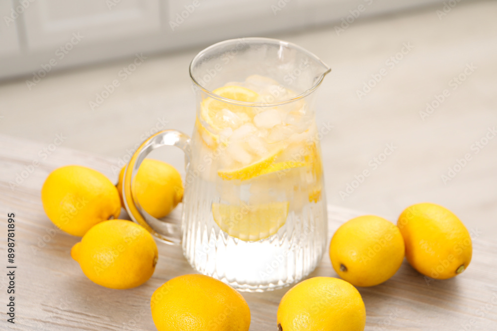 Freshly made lemonade in jug on white wooden table Freshly made lemonade in jug on white wooden table