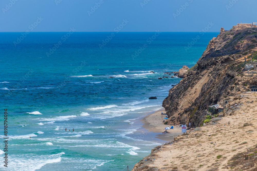 Rocky shoreline overlooking open sea swimmers Rocky shoreline overlooking open sea swimmers