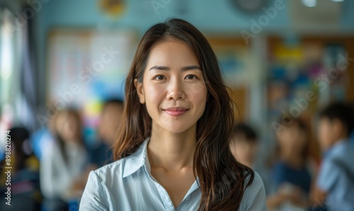 a photo portrait of a beautiful young female american school teacher standing in the classroom. students sitting and walking in the break. blurry background behind. Generative AI