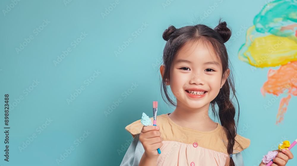 Promote our creative arts and crafts kits with AR integration, with an Asian girl displaying her artwork on a light blue background. Promote our creative arts and crafts kits with AR integration, with an Asian girl displaying her artwork on a light blue background.