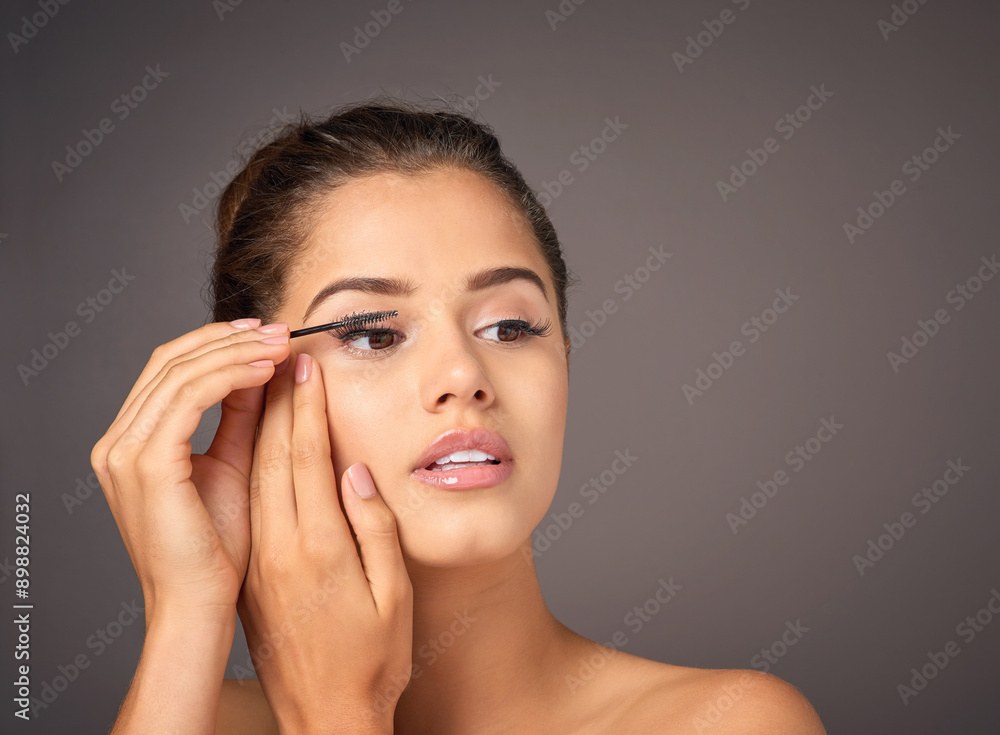 Mascara, makeup and woman in studio for cosmetics, beauty and wellness on gray background. Cosmetology, salon aesthetic and face of girl with eyelash brush for application, lash extension and glamour Mascara, makeup and woman in studio for cosmetics, beauty and wellness on gray background. Cosmetology, salon aesthetic and face of girl with eyelash brush for application, lash extension and glamour
