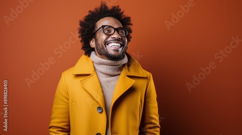 Smiling Man in Orange Jacket With Glasses