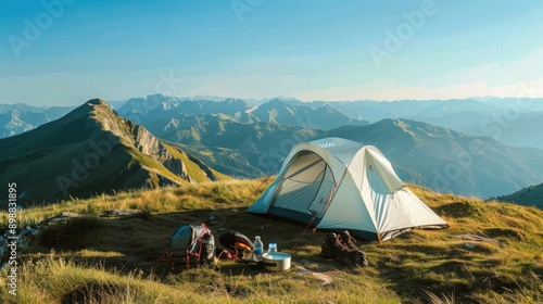 Hilltop camping scene with big white tent, gear like portable stove, water bottles, hiking boots, mountains in background, clear blue sky. Big camping tent gears