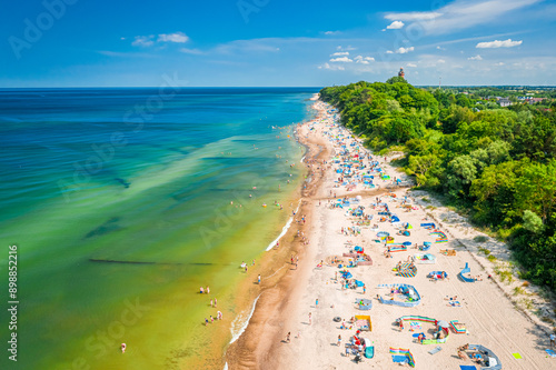 Fototapeta Naklejka Na Ścianę i Meble -  Flying above beach with people in Baltic Sea, Poland