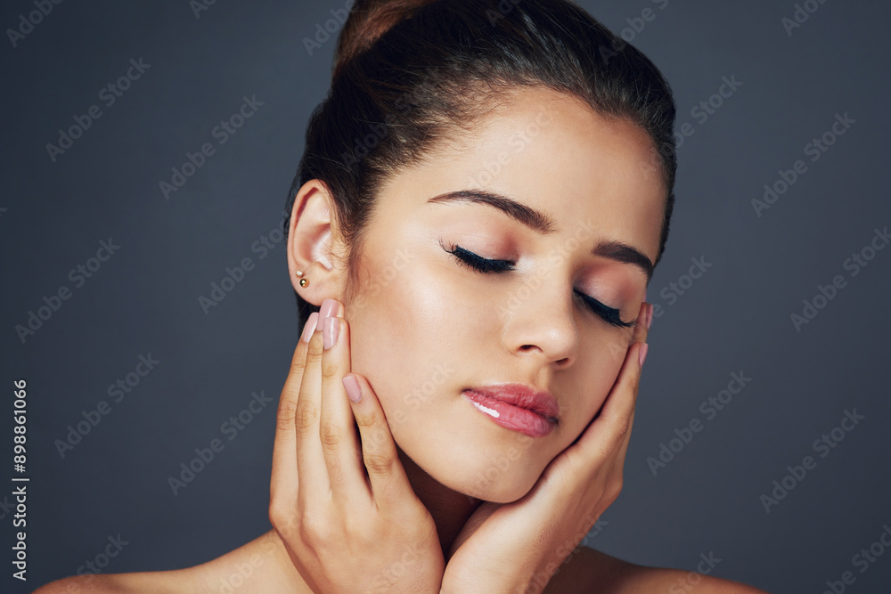 Beauty, relax and woman with hands on face in studio for cosmetics, wellness and satisfaction. Dermatology, spa and person with eyes closed for natural self care, salon and makeup on gray background Beauty, relax and woman with hands on face in studio for cosmetics, wellness and satisfaction. Dermatology, spa and person with eyes closed for natural self care, salon and makeup on gray background