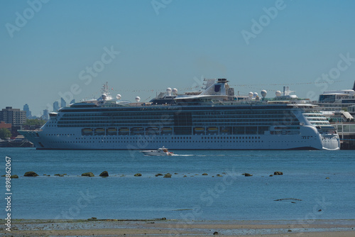 Modern Royal cruiseship cruise ship ocean liner Brilliance in port of Vancouver, British Columbia docked at terminal before Alaska summer cruising on sunny day with city skyline photo