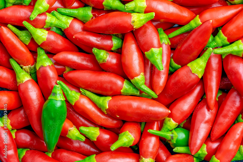 Set of small red chillies, one green isolated.Use for image background. Set of small red chillies, one green isolated.Use for image background.