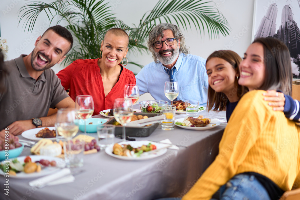 Portrait of cheerful Caucasian family posing with big smiles for a photo embraced indoor. Joyful people of diverse ages gathered sitting at table in a meal celebrating at home- Food and beverage Portrait of cheerful Caucasian family posing with big smiles for a photo embraced indoor. Joyful people of diverse ages gathered sitting at table in a meal celebrating at home- Food and beverage