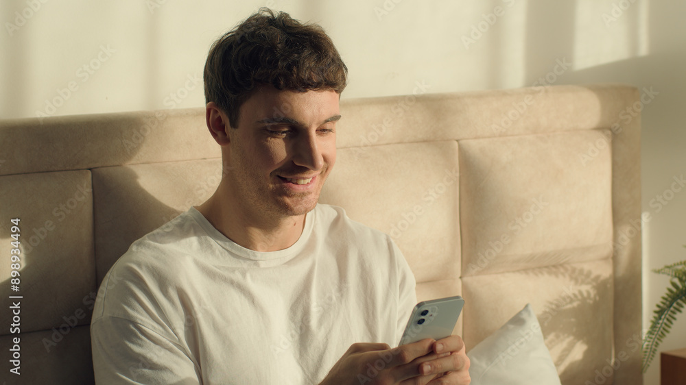Caucasian European man guy male bed bedroom texting mobile phone smartphone cellphone chatting sms internet communication web online technology enjoying positive smiling home message typing browsing Caucasian European man guy male bed bedroom texting mobile phone smartphone cellphone chatting sms internet communication web online technology enjoying positive smiling home message typing browsing