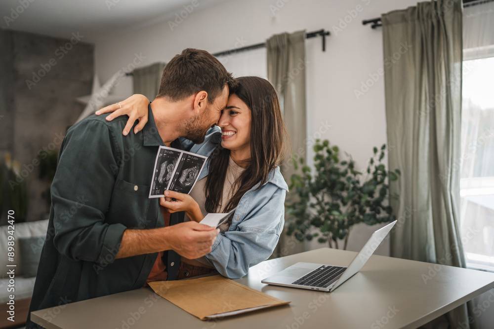 happy couple in love hold ultrasound picture of their first baby happy couple in love hold ultrasound picture of their first baby