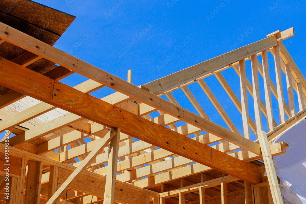 New home building framing with wooden truss, post beam framework in construction site New home building framing with wooden truss, post beam framework in construction site