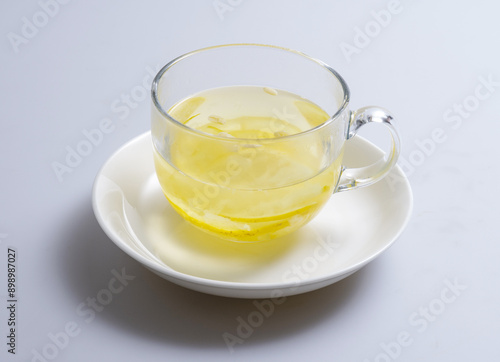 Close-up of Yuja-ch(Citrus Tea) with pine nut on glass cup and dish, South Korea 