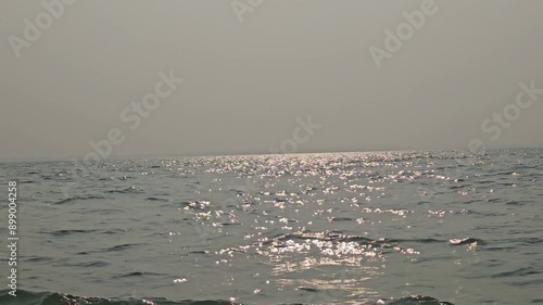 Landscape horizon view. Fishing boat moored with ocean waves and evening light at sunset at Chilika Lake. Odisha state on the east coast of India, mouth of the Daya River, flowing into Bay  Of Bengal.