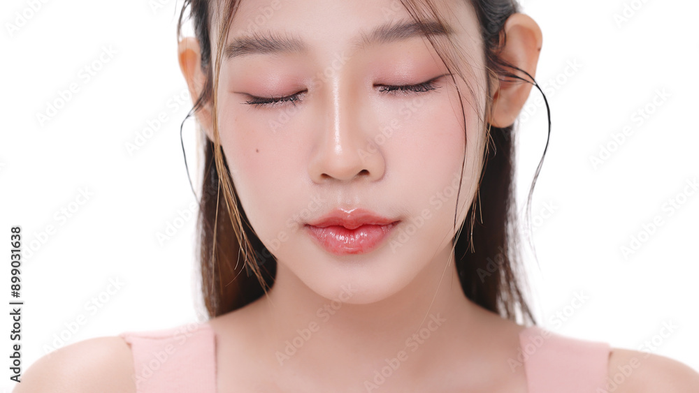 Beautiful young Asian woman with K beauty style makeup and perfect skin on isolated white background. Facial and skin care concept for commercial advertising. Beautiful young Asian woman with K beauty style makeup and perfect skin on isolated white background. Facial and skin care concept for commercial advertising.