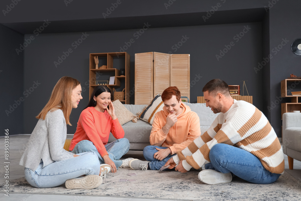 Group of young friends playing cards at home Group of young friends playing cards at home