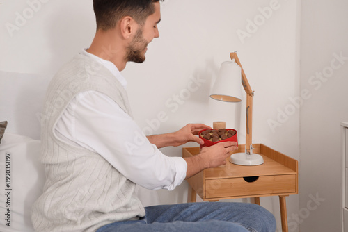 Handsome man taking box of ...