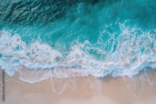 aerial view of pristine beach with turquoise waves gently lapping at white sand tropical paradise scene with crystalclear water and subtle foam patterns