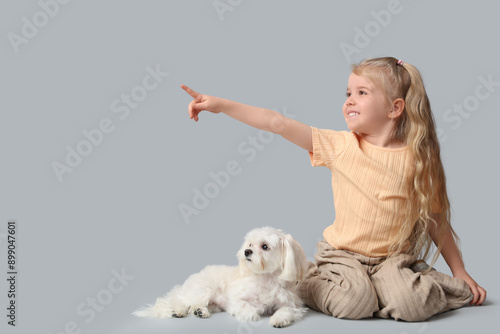 Cute little girl pointing a...