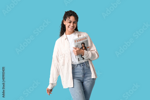 Smiling young woman holding...