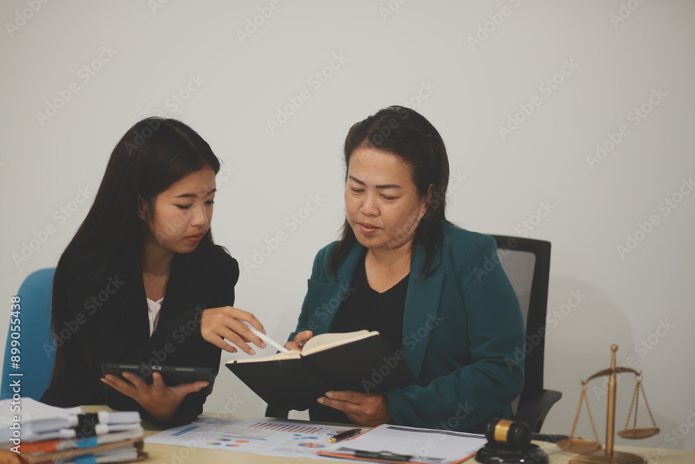 Pretty Asian female lawyer working and hammer, laptop, justice advice and legal concept. In office Pretty Asian female lawyer working and hammer, laptop, justice advice and legal concept. In office