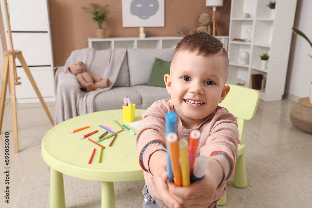 Cute little boy with felt-tip pens at home, closeup