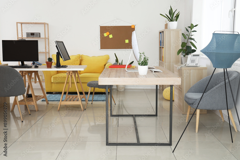 Interior of stylish office with modern workplaces and sofa Interior of stylish office with modern workplaces and sofa