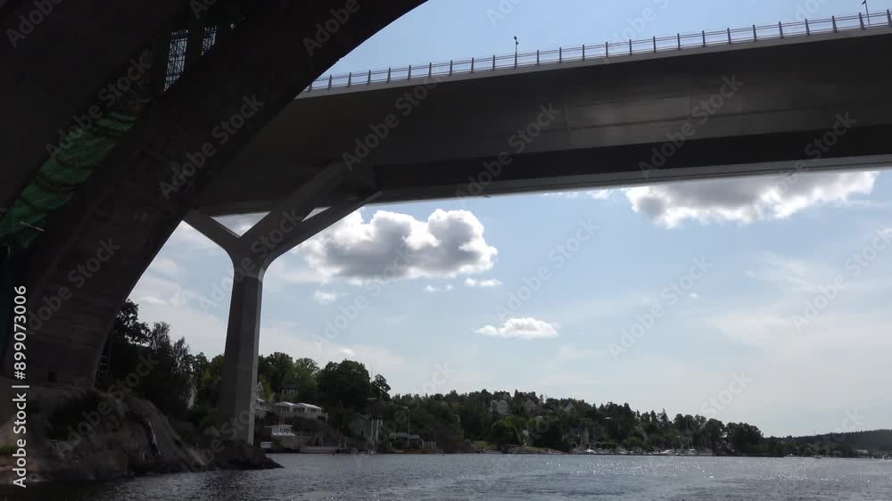 Stockholm, Sweden A small motorboat passes under the Skurubron bridge in the Nacka suburb. Stockholm, Sweden A small motorboat passes under the Skurubron bridge in the Nacka suburb.