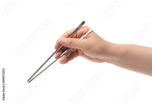 쇠 젓가락을 든 남성의 손 누끼(Close-up of a man's hand holding metal chopsticks)