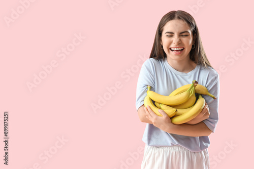 Happy young woman with bana...