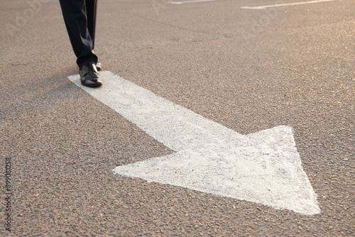 Businessman walking along r...